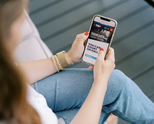 Image of customer using mobile phone to access HallPropane.com