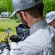 Hall technician checking a pressure gauge on a propane tank