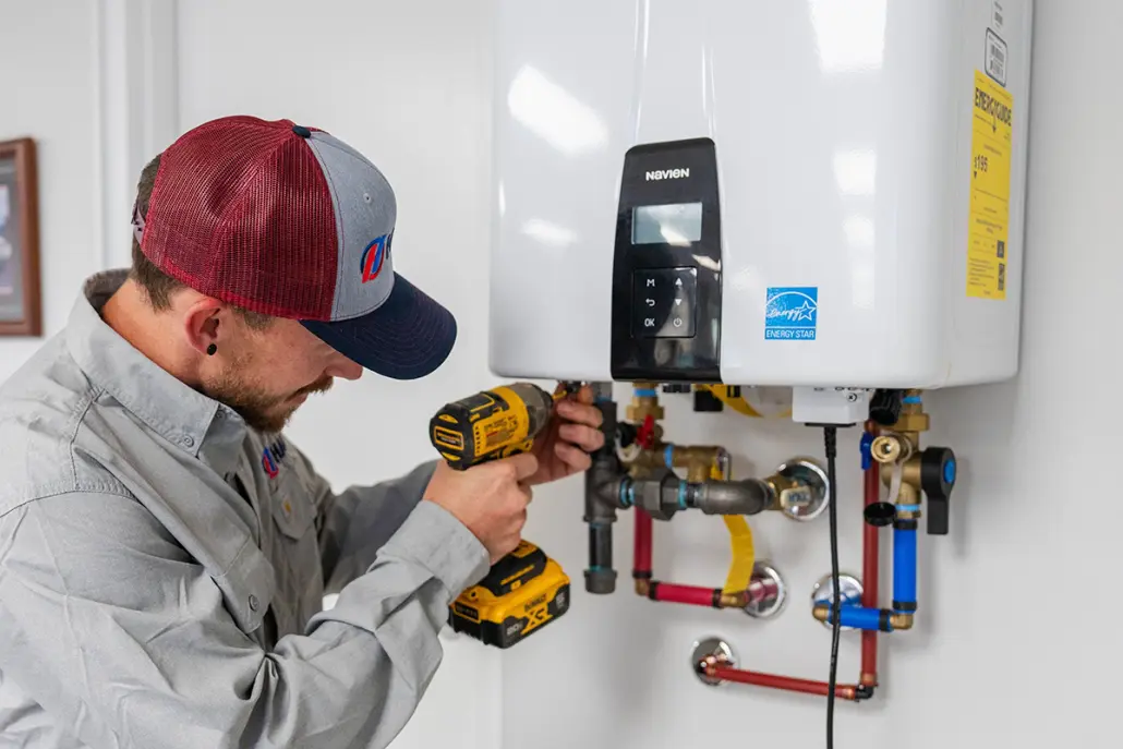 DSC03419 Hall technician performing maintenance on a tankless water heater
