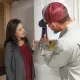 Hall technician showing tankless water heater to customers