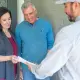 Hall service tech handing paperwork to customers