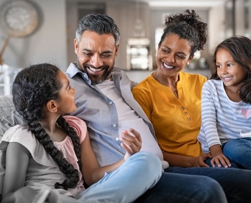 family sitting on couch together